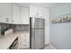 Modern kitchen with white cabinets, stainless steel appliances, and stylish backsplash for a contemporary feel at 151 Vista Hermosa Cir # 31C, Sarasota, FL 34242