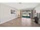 Bright living room features wood-style floors and sliding glass doors to the outdoor patio at 151 Vista Hermosa Cir # 31C, Sarasota, FL 34242