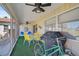 Screened in patio with green floor covering, a grill, and seating for outdoor enjoyment at 151 Vista Hermosa Cir # 31C, Sarasota, FL 34242