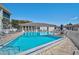 Community pool surrounded by lounge chairs and well-maintained landscaping at 151 Vista Hermosa Cir # 31C, Sarasota, FL 34242