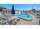 Community pool with lounge chairs, umbrellas, and pool-side tables at 151 Vista Hermosa Cir # 31C, Sarasota, FL 34242