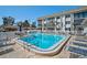 Large community pool with lounge chairs and surrounding palm trees at 151 Vista Hermosa Cir # 31C, Sarasota, FL 34242