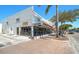 Exterior of a modern restaurant with outdoor seating, large windows, and stylish signage along a brick street at 151 Vista Hermosa Cir # 31C, Sarasota, FL 34242