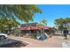 Exterior of a vibrant restaurant with a colorful mural, outdoor seating, and lush greenery under a clear sky at 151 Vista Hermosa Cir # 31C, Sarasota, FL 34242