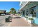Street view of the area with shops and tropical foliage on a sunny day at 151 Vista Hermosa Cir # 31C, Sarasota, FL 34242