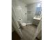 Well lit bathroom provides stone shower, vanity and commode at 15233 Omaha St, Hudson, FL 34667