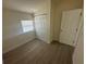 Bedroom featuring neutral walls, new flooring, closet space and natural light from the window at 15233 Omaha St, Hudson, FL 34667