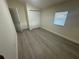 This bedroom offers wood floors, a window and closet at 15233 Omaha St, Hudson, FL 34667