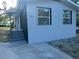 Exterior of updated home featuring a freshly painted exterior, new windows and manicured front yard at 15233 Omaha St, Hudson, FL 34667