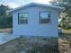 Exterior of home featuring a freshly painted exterior, new windows and a well maintained lawn at 15233 Omaha St, Hudson, FL 34667