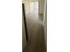 Hallway leading to a room with closet space and an exterior window, featuring new flooring at 15233 Omaha St, Hudson, FL 34667
