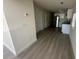 Inviting hallway leading to a modern kitchen featuring new flooring, paint and fixtures at 15233 Omaha St, Hudson, FL 34667