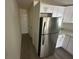 Open kitchen layout with stainless steel appliances, white cabinets and updated countertops at 15233 Omaha St, Hudson, FL 34667