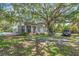 Spacious backyard featuring a screened in porch and pool with mature trees overhead at 1526 Ewing St, Nokomis, FL 34275
