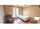 Cozy bedroom with a single bed, arm chair, and natural light from the window at 1526 Ewing St, Nokomis, FL 34275