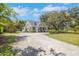 Charming home with well-manicured lawn, mature trees, and a long driveway at 1526 Ewing St, Nokomis, FL 34275