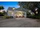 Charming home featuring a welcoming front porch with stately columns and a well-manicured gravel driveway at 1526 Ewing St, Nokomis, FL 34275