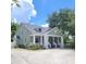 Charming home featuring well-manicured lawns, inviting front porch, and mature trees offering curb appeal at 1526 Ewing St, Nokomis, FL 34275