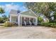 Inviting two-story home with a charming front porch and beautifully landscaped with ample parking at 1526 Ewing St, Nokomis, FL 34275