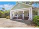 Beautiful exterior view of the charming home with a spacious porch, complemented by a vibrant red front door at 1526 Ewing St, Nokomis, FL 34275