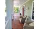 Relaxing front porch with comfortable seating, showcasing charming decor, perfect for enjoying the outdoors at 1526 Ewing St, Nokomis, FL 34275
