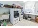 Well-organized laundry room with modern washer/dryer, storage, and natural light at 1526 Ewing St, Nokomis, FL 34275