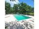 Backyard pool and lounging area with clean, clear water and ample seating space at 1526 Ewing St, Nokomis, FL 34275
