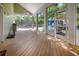 Large screened porch with wood floors, providing ample space for outdoor living and entertaining at 1526 Ewing St, Nokomis, FL 34275