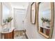 Inviting entryway with decorative mirrors, console tables, and stylish decor elements at 17409 Haysack Ter, Lakewood Ranch, FL 34211
