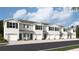 Charming townhomes featuring a light grey facade, black shutters, and attached one car garages at 17413 Haysack Ter, Lakewood Ranch, FL 34211