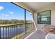 Outdoor balcony with beautiful views of a lake and trees on a sunny day at 18114 Gawthrop Dr # 402, Bradenton, FL 34211