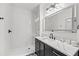 Modern bathroom features a frameless glass shower, sleek vanity with marble countertop, and black and white patterned flooring at 18114 Gawthrop Dr # 402, Bradenton, FL 34211