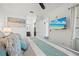 A spacious bedroom offering a view of the ensuite bath and an additional mounted TV at 18114 Gawthrop Dr # 402, Bradenton, FL 34211