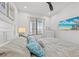 Comfortable bedroom featuring a queen bed with beach-themed decor and a flat-screen TV at 18114 Gawthrop Dr # 402, Bradenton, FL 34211