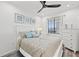 Cozy bedroom with soft bedding, natural light, ceiling fan, and dresser, creating a peaceful retreat at 18114 Gawthrop Dr # 402, Bradenton, FL 34211