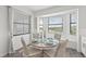 Bright eat-in kitchen nook with a round table, wicker chairs, and a bay window with a scenic view at 18114 Gawthrop Dr # 402, Bradenton, FL 34211