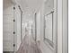 Hallway view showcasing wide plank floors and barn door closets for a modern look at 18114 Gawthrop Dr # 402, Bradenton, FL 34211