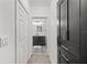 Hallway view leading to a bathroom featuring stylish black and white patterned tile flooring and modern vanity at 18114 Gawthrop Dr # 402, Bradenton, FL 34211