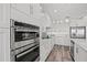 Close up on modern stainless steel oven and range appliances with sleek white cabinetry in a kitchen at 18114 Gawthrop Dr # 402, Bradenton, FL 34211