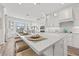 Modern kitchen featuring an island with seating, white cabinets, and stainless steel appliances at 18114 Gawthrop Dr # 402, Bradenton, FL 34211