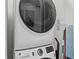Modern stacked washer and dryer set in a well-lit laundry area with cleaning supplies at 18114 Gawthrop Dr # 402, Bradenton, FL 34211