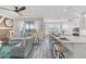 Open-concept living area showcasing a kitchen island with seating, a cozy living room, and hardwood floors at 18114 Gawthrop Dr # 402, Bradenton, FL 34211