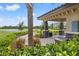 Poolside pavilion with BBQ and seating area near a lake surrounded by lush landscape at 18114 Gawthrop Dr # 402, Bradenton, FL 34211