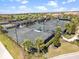 Aerial view of well-maintained tennis courts surrounded by lush landscaping in a vibrant community at 18114 Gawthrop Dr # 402, Bradenton, FL 34211