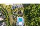 Aerial view of a pool, playground, and amenities in a lush, tropical community at 1824 Woodleaf Hammock Ct, Bradenton, FL 34211