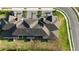 Aerial view of the home featuring landscaping, private parking and the roof at 1824 Woodleaf Hammock Ct, Bradenton, FL 34211