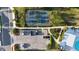 Overhead shot of community tennis courts, parking, and lush landscaping near pool area at 1824 Woodleaf Hammock Ct, Bradenton, FL 34211