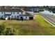 View of the home's backyard, featuring a patio and spacious lawn at 1824 Woodleaf Hammock Ct, Bradenton, FL 34211