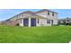 A lush backyard featuring green grass and the exterior of the home at 1824 Woodleaf Hammock Ct, Bradenton, FL 34211