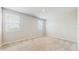 Spacious bedroom featuring neutral carpeting, crisp walls, and double hung windows at 1824 Woodleaf Hammock Ct, Bradenton, FL 34211